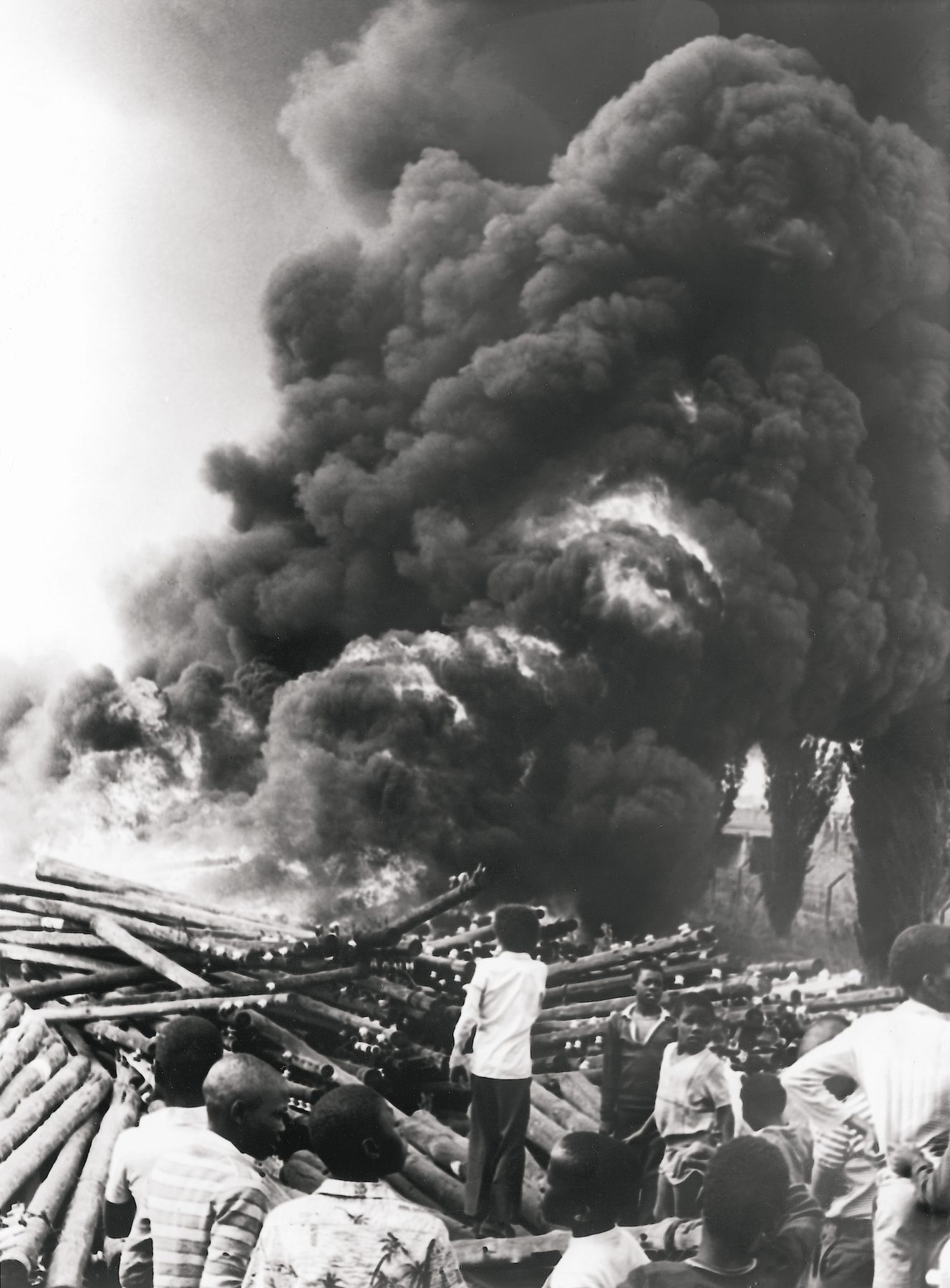 Children look on as Khwezi Station, Soweto, goes up in smoke.